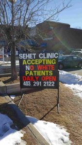 Clinic owner Mustansir Raj says he was horrified to see someone had changed the sign to his clinic including what he called some "ugly" and "racist" language. 
