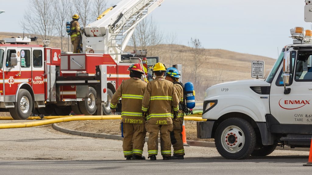 Firefighters work to put out a fire in a south-east industrial park on 52 Street near Erinwoods in Calgary on Wednesday, April 5, 2017. The fire affected power lines and some vehicles, causing black smoke to fill up the air for a while. (Photo by Chelsey Harms/660 NEWS)
