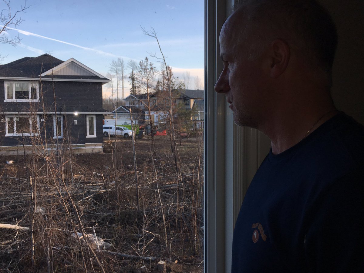 Mike Bennett looks out the window of his rebuilt home in Fort McMurray.